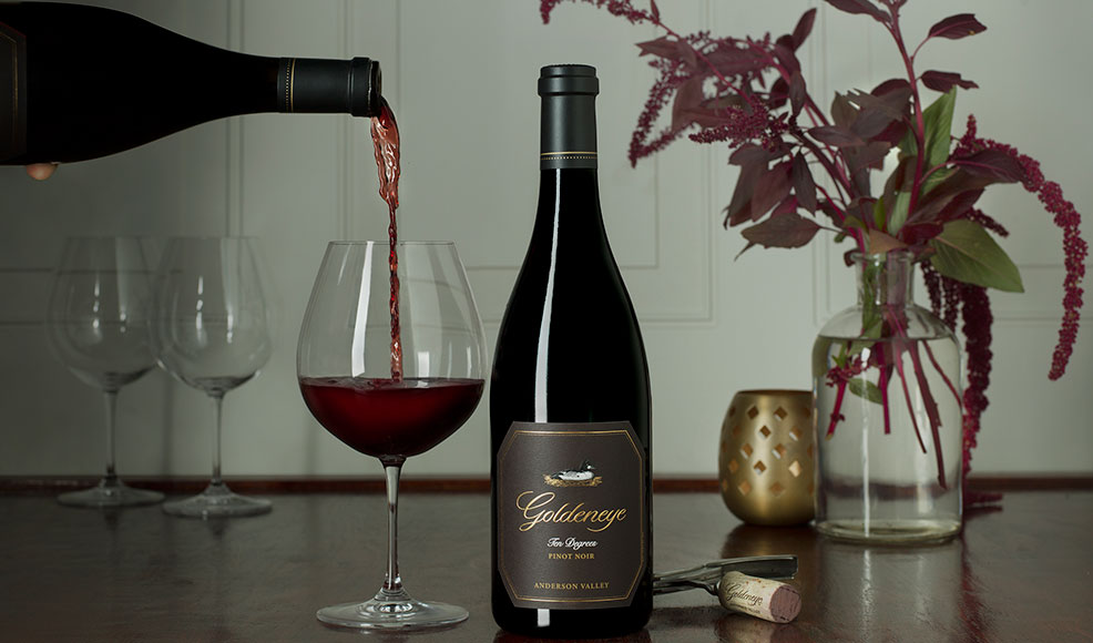 Pouring Goldeneye Ten Degrees Pinot Noir wine into a glass