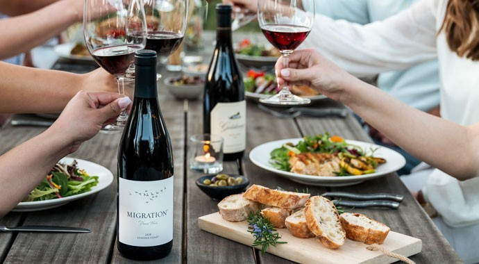 Migration wines on a table with wine and food